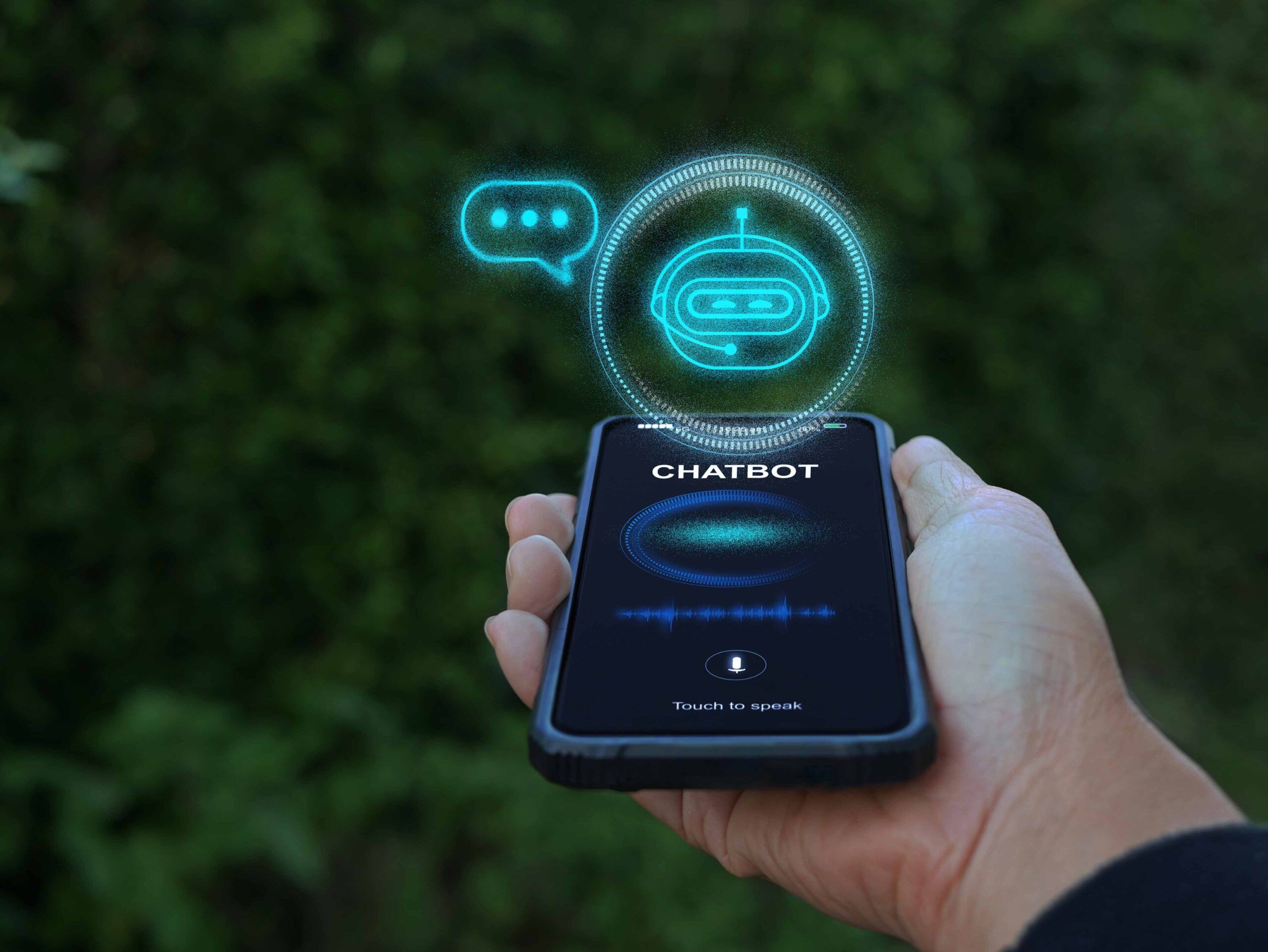 A hand holding a smartphone displaying a chatbot interface on the screen, illustrating digital communication.
